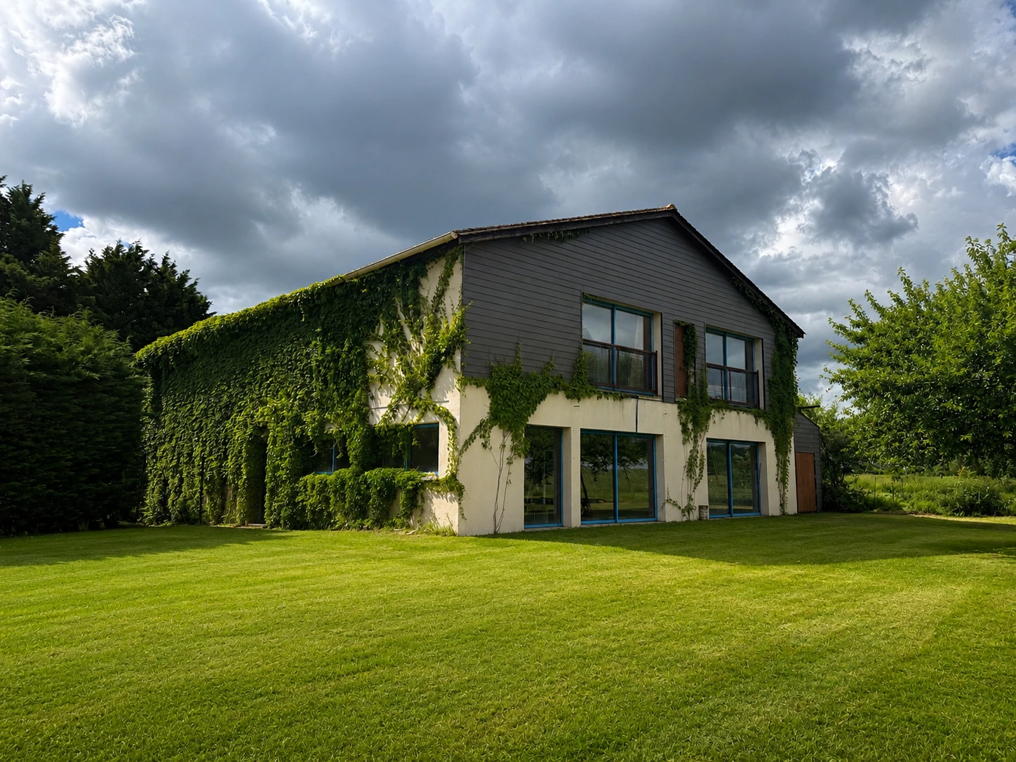 Sports complex exterior with ivy-covered elevations and open lawn