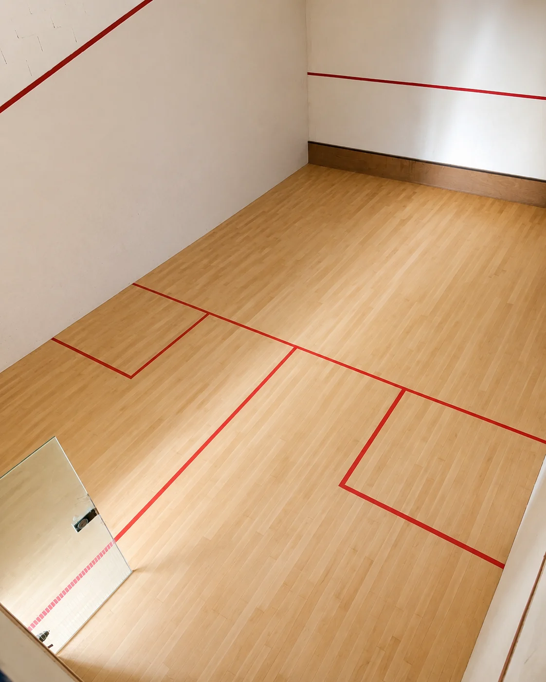 Freshly finished squash court floor with red lines